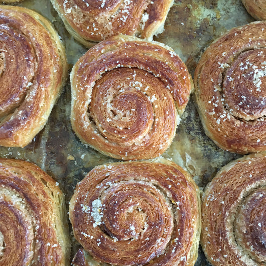 An aromatic and sweet start to your day, flavored with organic orange zest, cardamom, and cinnamon.  Ingredients: Croissant dough, sugar*, orange zest*, spices